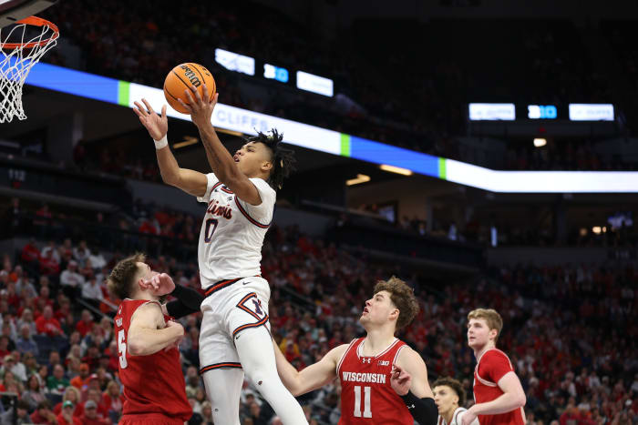 Mar 17, 2024; Minneapolis, MN, USA; Illinois Fighting Illini guard Terrence Shannon Jr. (0) goes to the basket over Wisconsin Badgers forward Tyler Wahl (5) in the second half at Target Center.